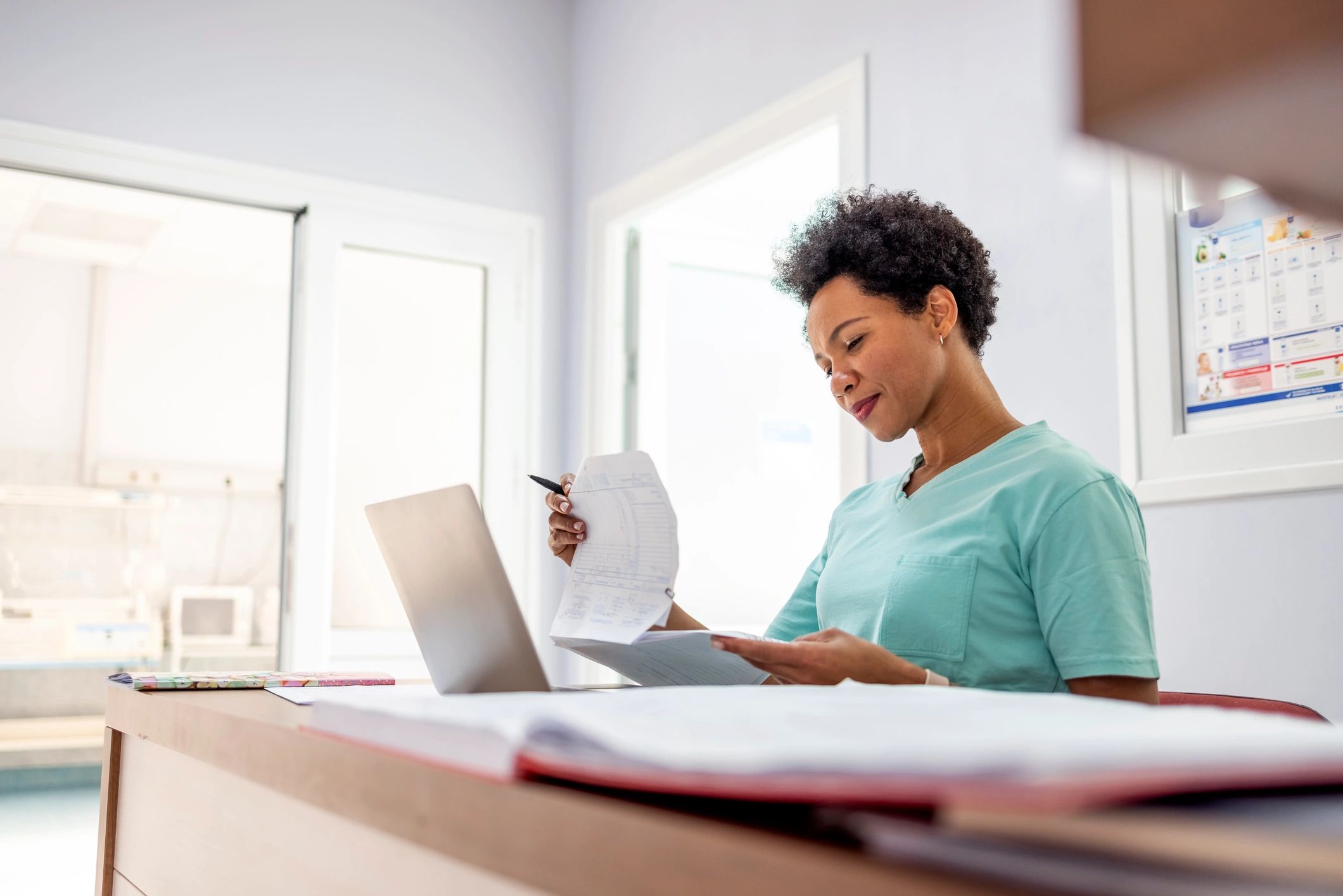 Nurse reviewing paperwork for a referral