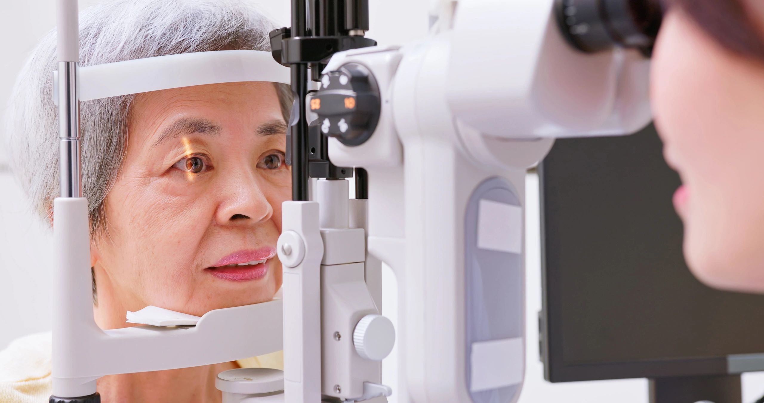 Eye exam being performed for an older adult